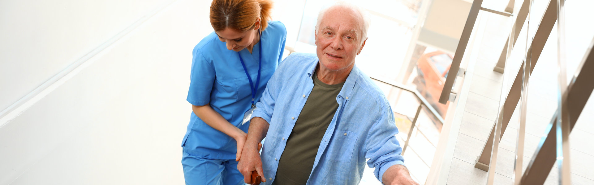 female caretaker helps the elderly man