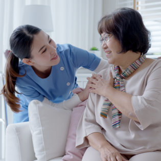 female caretaker talk to elderly woman