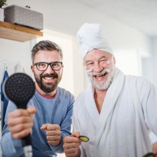 aide and elderly man smiling