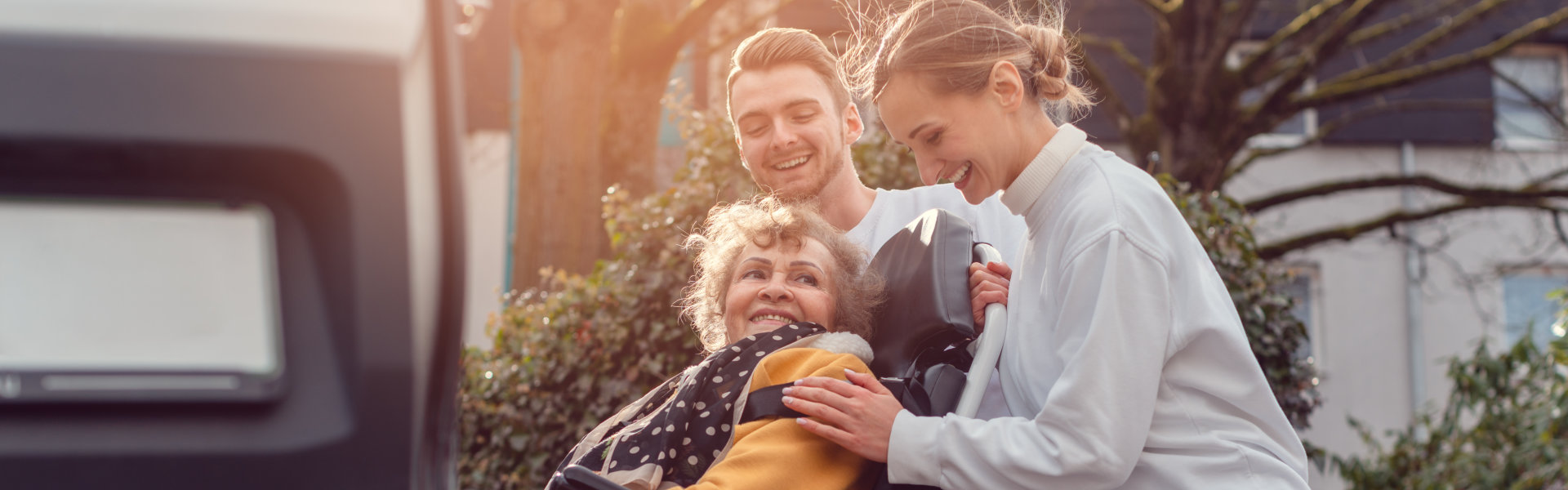 caregivers assisted an elderly woman in getting on the car