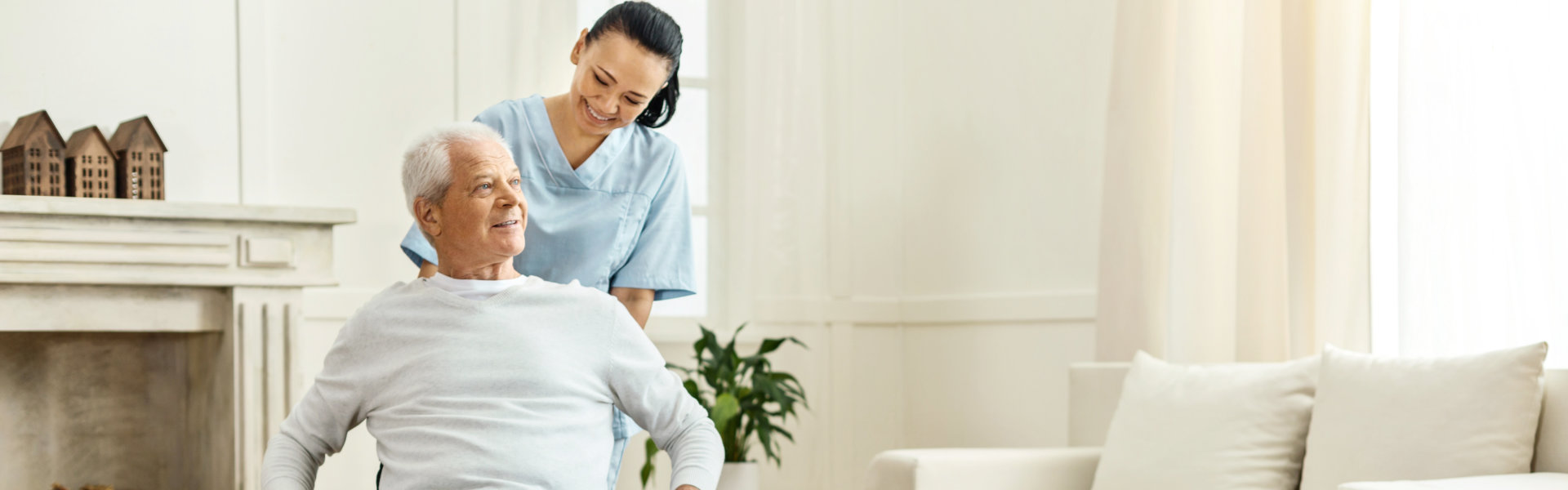 Cheerful positive caregiver moving a wheelchair