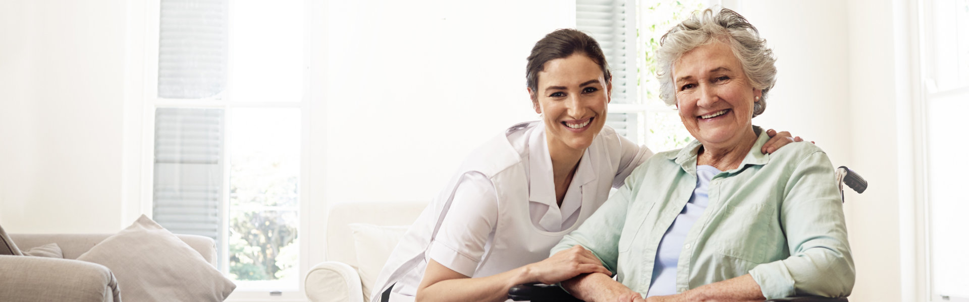 Caregiver helping elderly woman patient